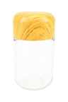Tall clear glass storage jar featuring square-shouldered yellow wood-grain tamper cap, shown upright on white backdrop for size comparison