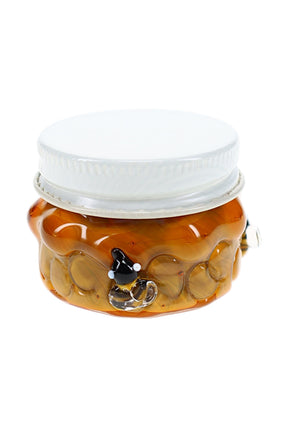 Amber honeycomb glass terp jar with white screw-top lid, bee accents, and compact 1½″ storage shape