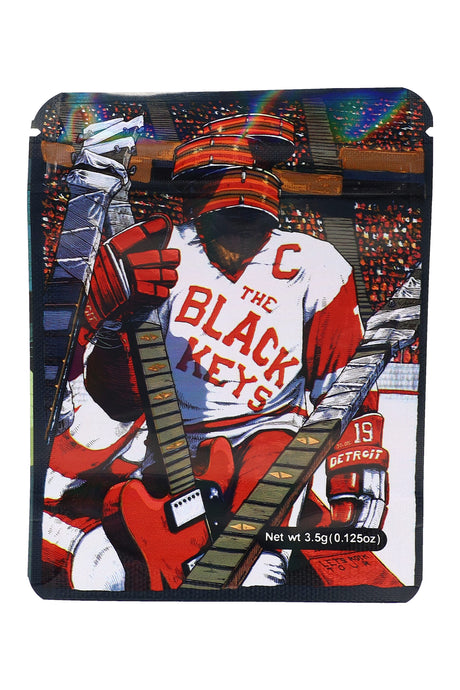 Stadium-scene ⅛ oz pouch with hockey gear and guitars reading “The Black Keys”; 3.5 g storage bag in band-style art.