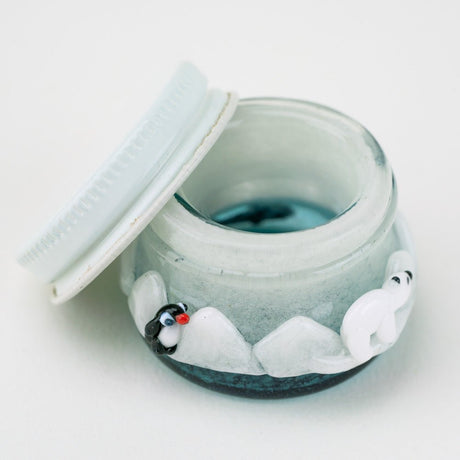 Open Empire Glassworks terp jar showing white lid, blue glass interior, and snowy arctic artwork