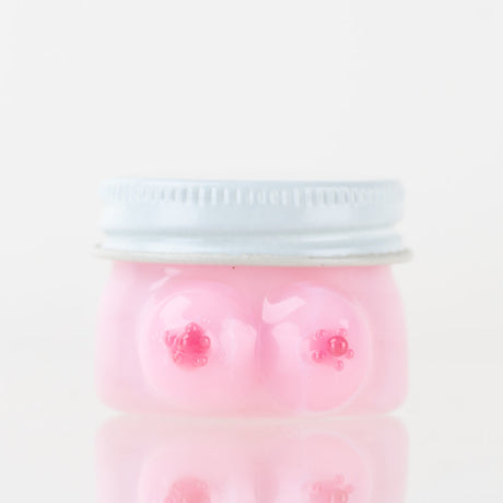 Empire Glassworks Boobies terp jar front view with pink glass body and silver fitted lid