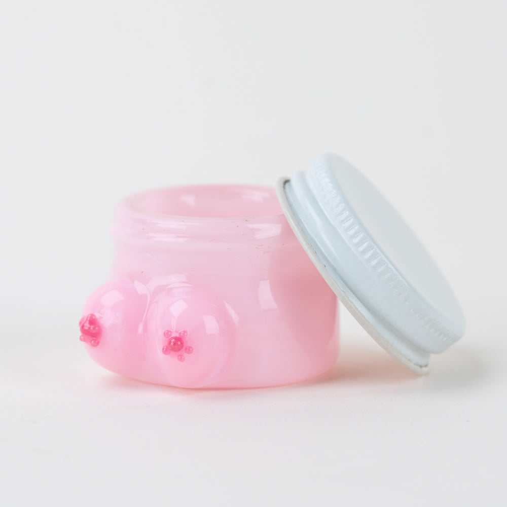 Open Empire Glassworks Boobies concentrate jar showing pink interior and removable silver lid