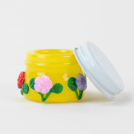 Open Empire Glassworks Sunshine Garden concentrate jar showing white lid and yellow glass interior