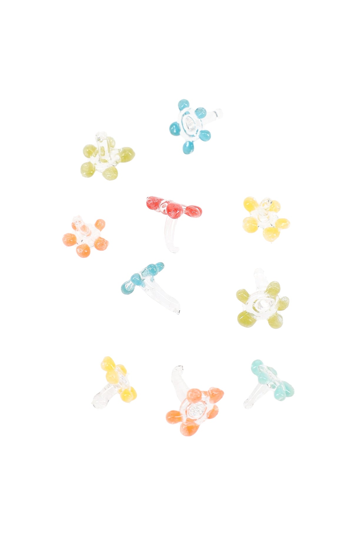 Assorted glass daisy pipe screens scattered on white, each with six petals and a short stem in mixed colors.