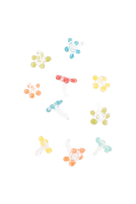 Assorted glass daisy pipe screens scattered on white, each with six petals and a short stem in mixed colors.
