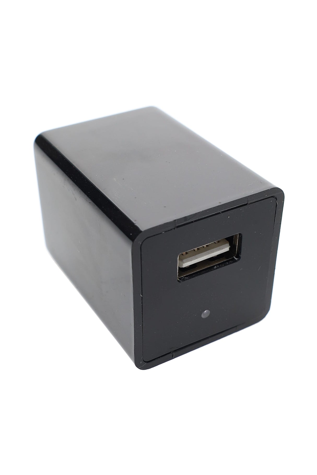 Black USB wall charger with hidden camera lens and single USB-A port, angled view on white background, compact rectangular design