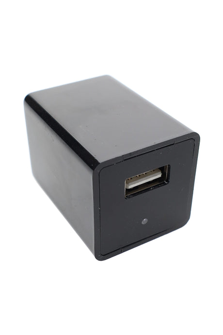 Black USB wall charger with hidden camera lens and single USB-A port, angled view on white background, compact rectangular design