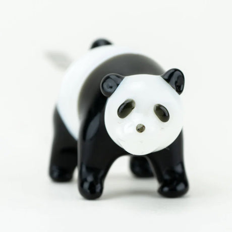 Close front view of sculpted panda face on glass dab tool highlighting eyes, nose, and ears against clean white background.
