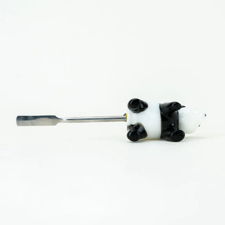 Panda dabber lying on its back to display flat stainless scoop length and attachment point, photographed on white studio surface.