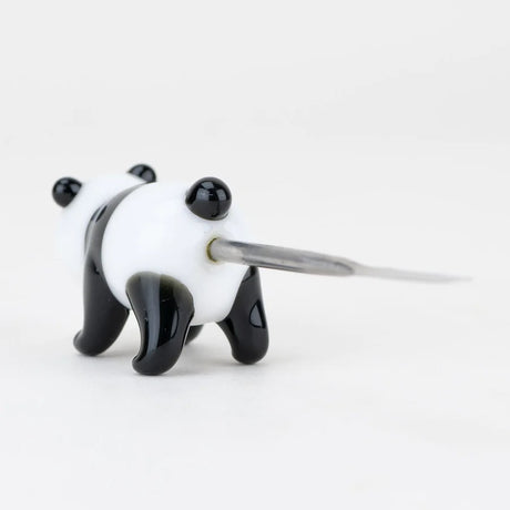 Rear close-up of panda glass figure with stainless scoop entering body, showing secure joint and glossy paw details.