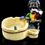 Resin ashtray with seated Rasta in tie-dye shirt beside rustic bucket-style bowl and extra cup holder, glossy black stage.