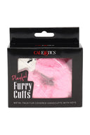 Retail box of Playful Furry Cuffs in pink, metal handcuffs covered in soft faux fur with keys; giftable black packaging.