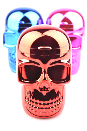 Chrome plastic skull ashtray in vivid red foreground with blue and pink variants blurred behind, 3.5-inch novelty tabletop accessory.