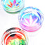 Round 4-inch glass ashtrays sporting pastel cannabis leaf graphics in aqua, purple and rasta gradients; deep bowl, three grooves, studio overhead lighting.