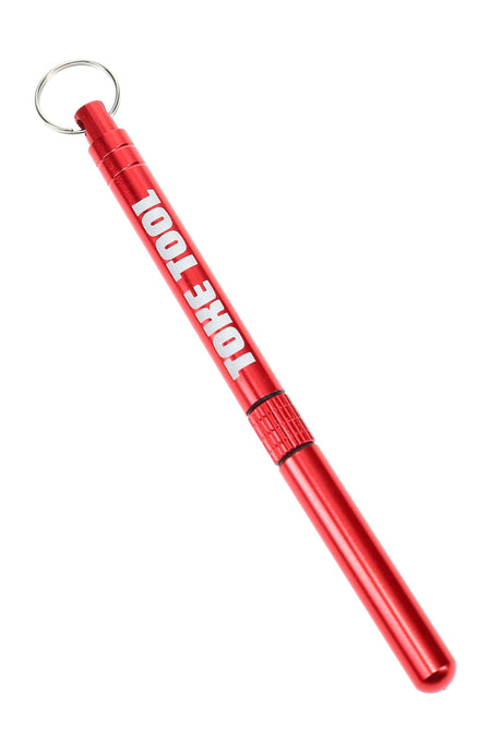Red Stoned Earth Toke Tool closed with key ring, slim anodized aluminum case for discreet on-the-go packing and clearing.
