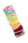 4″ white sage smudge stick wrapped in layered rainbow rose petals and tied with white string; compact aromatic bundle.