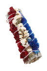 Patriotic red, white, and blue flower-wrapped white sage smudge bundle; tightly bound with white string; 4″ size.
