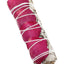 White sage smudge bundle wrapped in deep magenta rose petals; 4″ aromatic stick tied with cotton string.