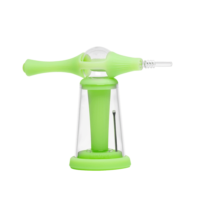 Green dab straw resting in station stand beside glass dome bubbler, showing heat-safe base and grip sleeve