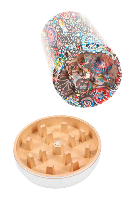 Close-up of the detachable grinder from the soda can water pipe, showing diamond teeth and colorful can body interior.