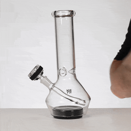 MJ Arsenal Nexus bong displayed on tabletop highlighting the black suction base and compact glass profile