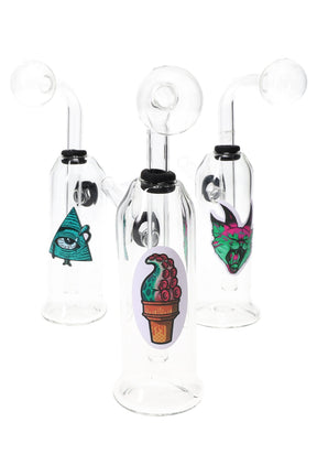 US-made thick glass oil burner rig with clear bubble burner, angled straw mouthpiece, and assorted graphic decals on the chamber; sold individually.