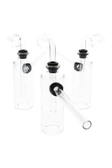 US-made 4″ clear glass bottle oil burner bubbler with globe burner and sidecar mouthpiece, rubber grommet seal; lightweight ~60 g on white background.
