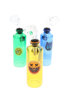 US-made 4″ colored glass bottle oil burner with clear globe and sticker decal; about 55 g; assorted green, yellow, and blue.