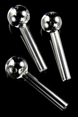 Three thick glass oil burner pipes with blue dot accents, diagonally arranged on glossy black background for full-stem view.