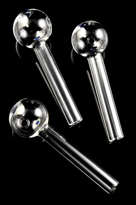 Three thick glass oil burner pipes with blue dot accents, diagonally arranged on glossy black background for full-stem view.