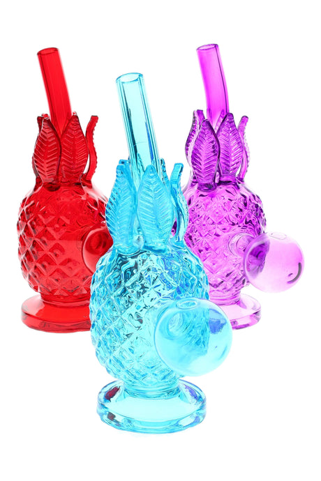 Textured glass pineapple oil burner rig, 5.5″ tall, trio of red, aqua, and purple colors on white background, round base.