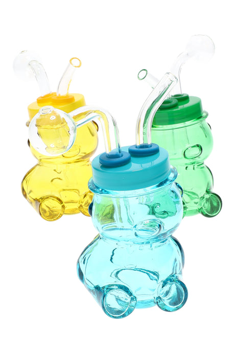 Assorted colored glass bear oil burner rigs in mixed colors, compact 3½″ novelty pieces on white background
