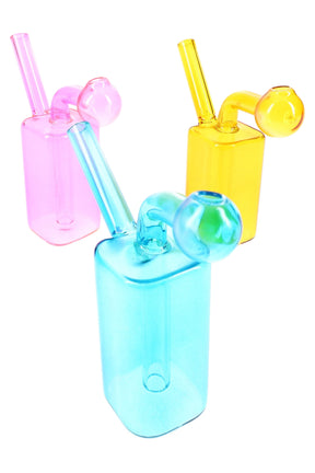 Small 2.5-inch colored glass oil burner rig with square chamber, angled mouthpiece, and globe burner head; random blue, pink, or yellow.