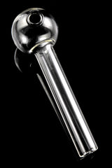Clear thick glass straight oil burner pipe on black background showing rounded chamber and 4″ tube