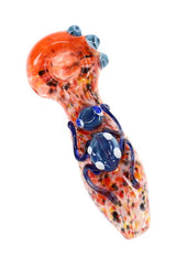 Orange silver fumed frit glass hand pipe with blue spotted critter detail and compact spoon shape
