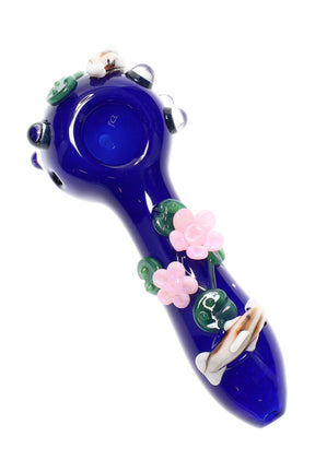 Top-down koi pond glass hand pipe with deep-blue body, pink blossoms, lily pads, and clear marbles