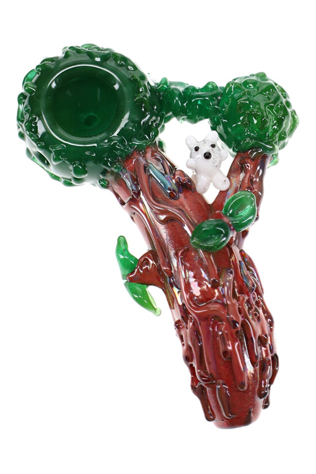 Empire Glassworks glass hand pipe shaped like a tree trunk with green canopy and white squirrel accent