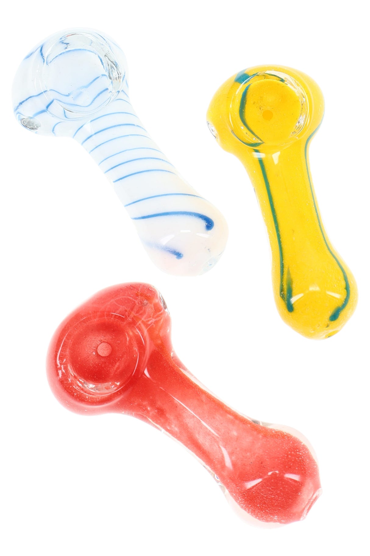 Trio of 2½ inch striped frit glass spoon pipes in white, yellow, and red colorways arranged diagonally on a bright white backdrop.