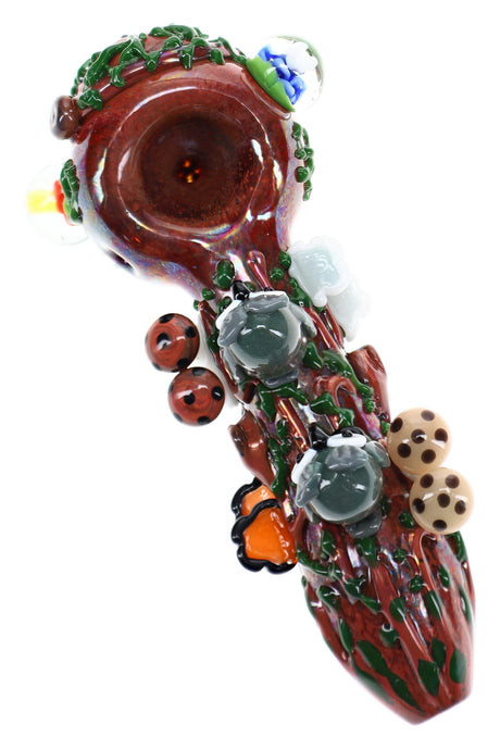 Empire Glassworks glass hand pipe with log-brown body, green vines, gray owls, and mushroom accents