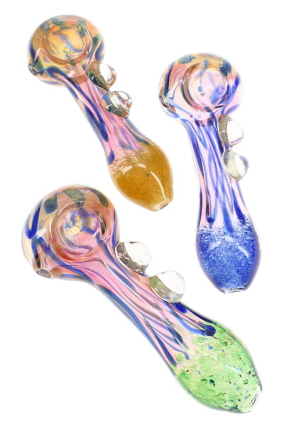Three assorted gold fumed frit glass spoon pipes with striped bodies, marble accents, and colorful ends