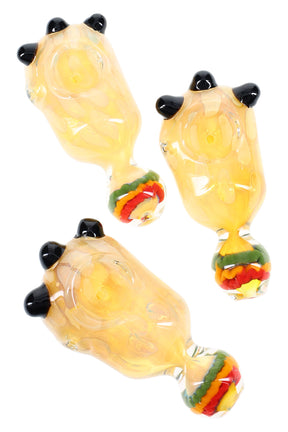 Four-inch silver-fumed color-changing glass spoon pipe with Rasta swirl mouthpiece and black marble roll-stops on the bowl.