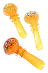 Assorted color-changing frit ring glass spoon pipes showing mixed bowl accents and raised ring grips in warm amber tones