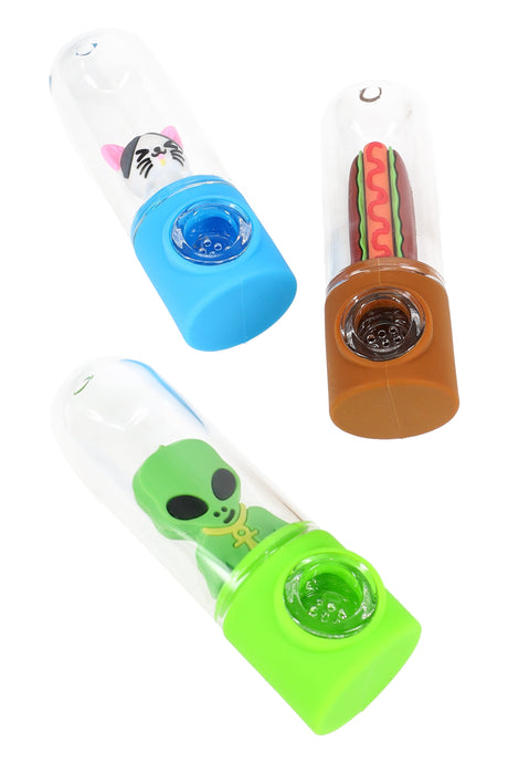 Three capsule style silicone and glass character hand pipes laid on their sides showing cute cat, alien and hot dog figures and built in glass screen bowls