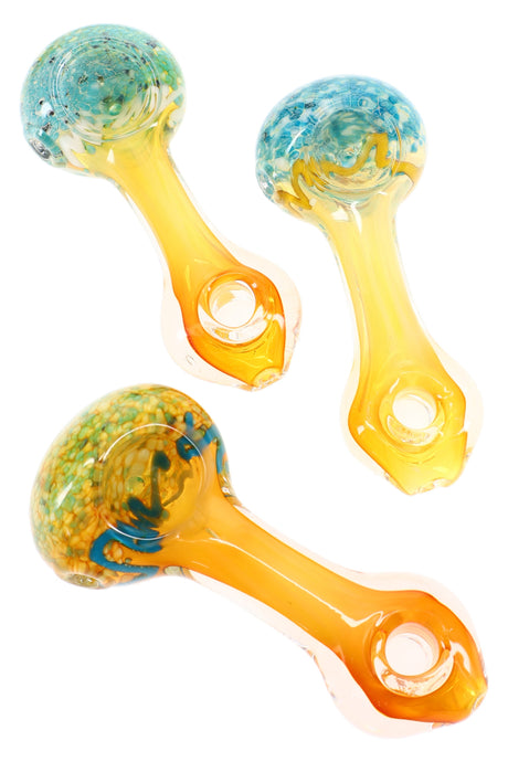 4.5 inch donut hole frit gold fumed glass hand pipe with color changing bowl and amber stem, shown in assorted unique patterns