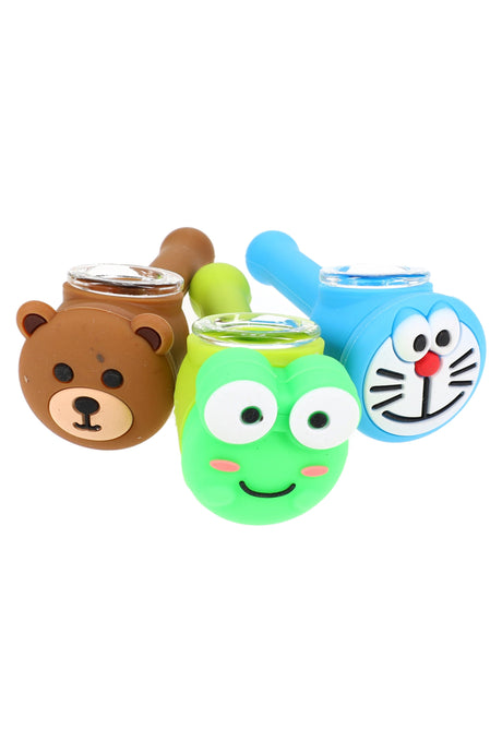 Front view of three 4 inch silicone character silicone hand pipes with glass screen bowls showing cute bear, frog and cat faces together