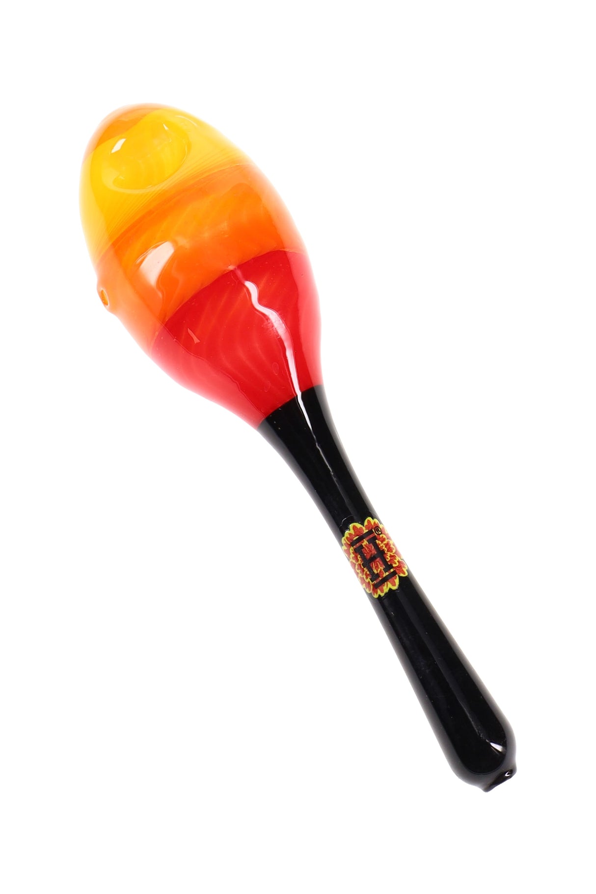 Hemper Dia De Los Muertos maraca glass hand pipe with red, orange and yellow head on black handle shown on white background.