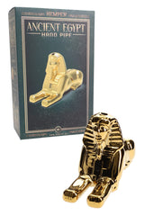 Hemper gold Sphinx glass hand pipe displayed in front of Ancient Egypt gift box, showing full statue profile and retail packaging.