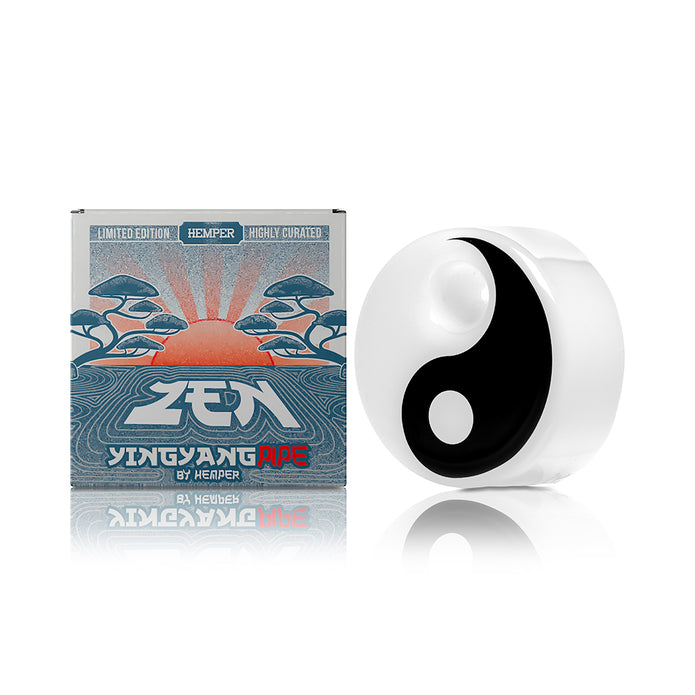 Hemper Yin Yang puck hand pipe beside branded retail box, side view showing bowl dot and compact profile