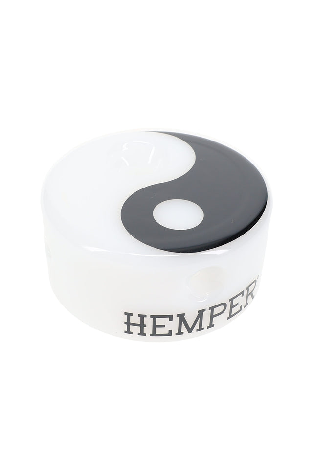 Top angle of Hemper Yin Yang puck glass hand pipe, glossy black-and-white symbol over opaque white base