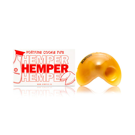 Studio photo of yellow fortune cookie glass hand pipe showing curved cookie profile and smooth glossy finish